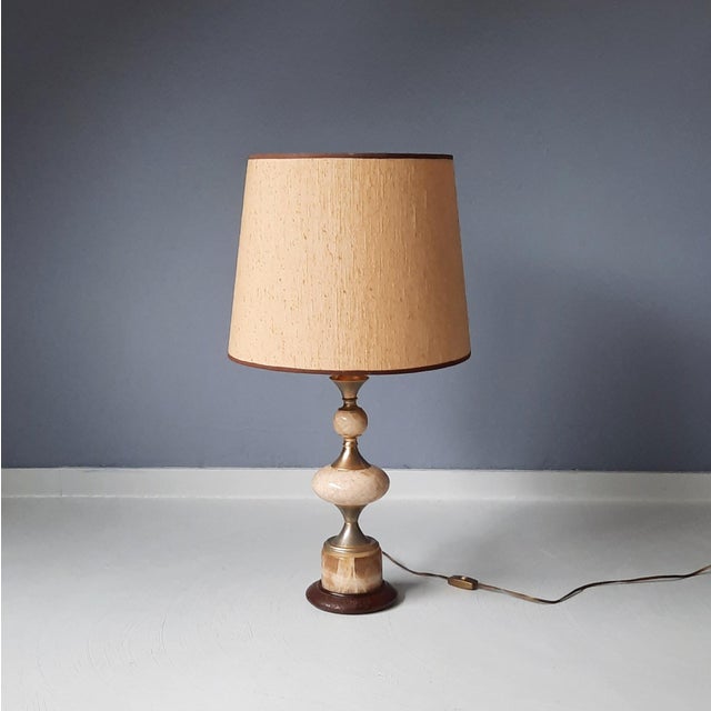 This table lamp is made of onyx, brass-colored elements and wood. Modern design from the 1960s. Original vintage shade....
