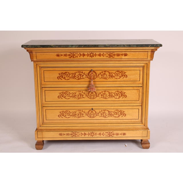 Charles X style inlaid chest of drawers with a marble top, circa 1980's. With a rectangular marble top with rounded front...