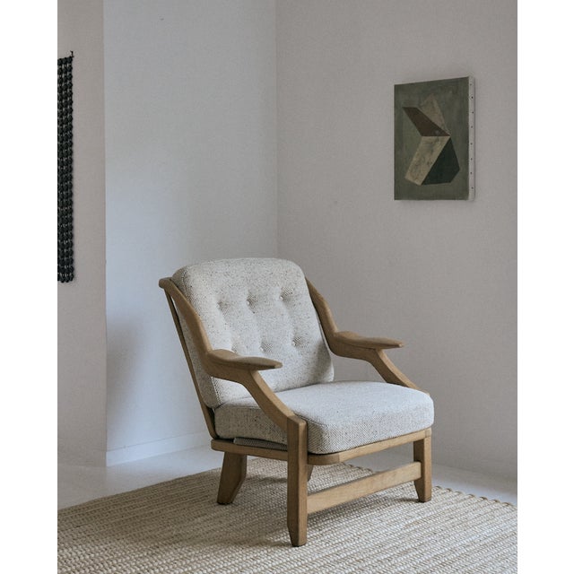 Guillerme & Chambron "Grégoire" lounge chair, for Votre Maison. This solid oak armchair from France has a unique frame...