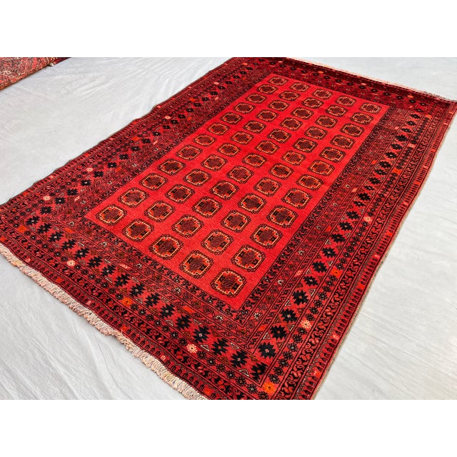A vintage Afghan Turkmen Ersari rug carrying eleven rows of small quartered Tekke-type güls in a tight, disciplined grid...