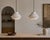 A pair of handcrafted ceramic pendant lights by Miri Mara, a California-based studio known for its refined, material-...