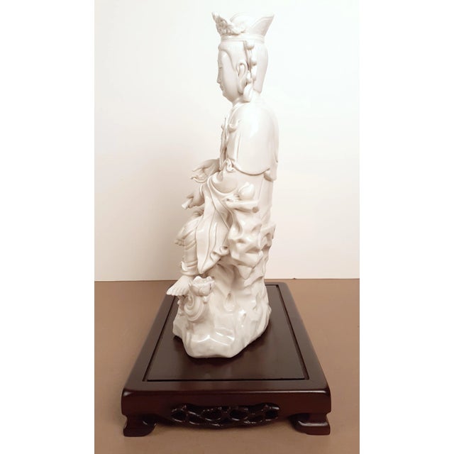 Chinese De Hua Zizhai Kuan Yin with Red Boy. This is a rare, finely carved, depiction of a bare-breasted Kuan Yin seated...