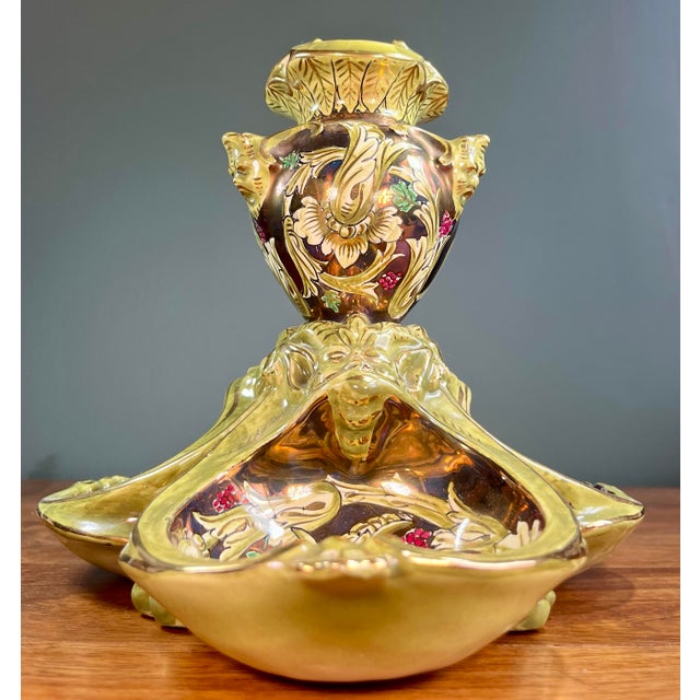 Italian green luster majolica tripartite centerpiece urn/vase. Beautiful leaf and floral designs with layered faces adding...