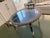A striking Moroccan footed tray in hand-chased silver-tone metal, finished with richly detailed arabesque, scrolling vine,...
