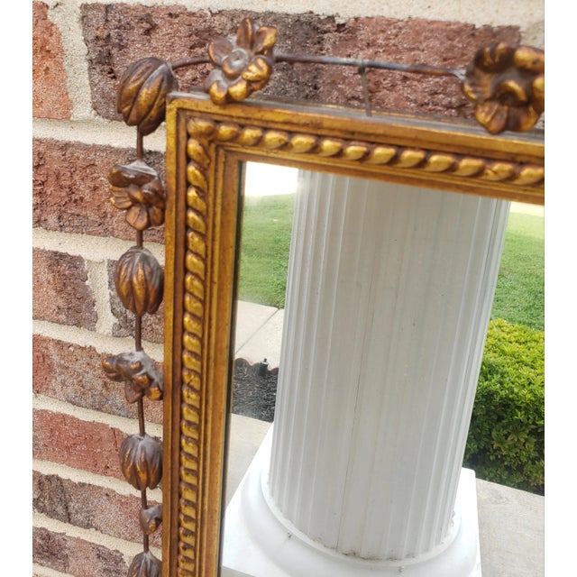 Early 20th Century French Empire style Giltwood Frame Ornate Wall Mirror measuring 25.5" in width and 50" in height....