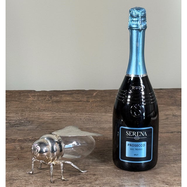 Late 20th century Godinger silver-plated bee trinket or candy box with a clear glass body and hinged wings forming the...