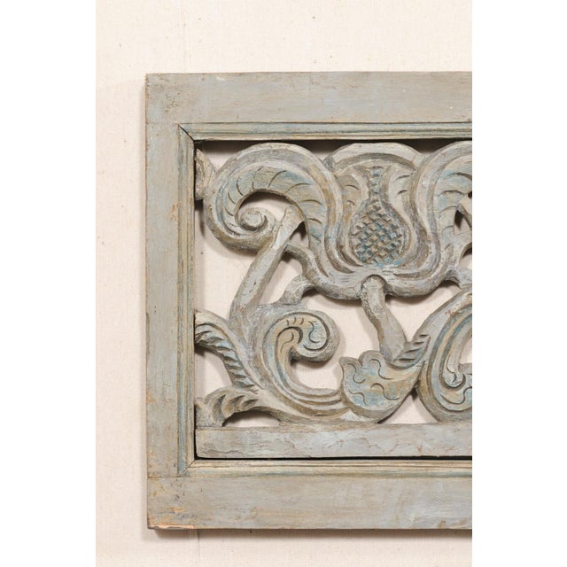 A Spanish carved and painted wood wall panel from the early 20th century. This antique wall decoration from Spain has a...