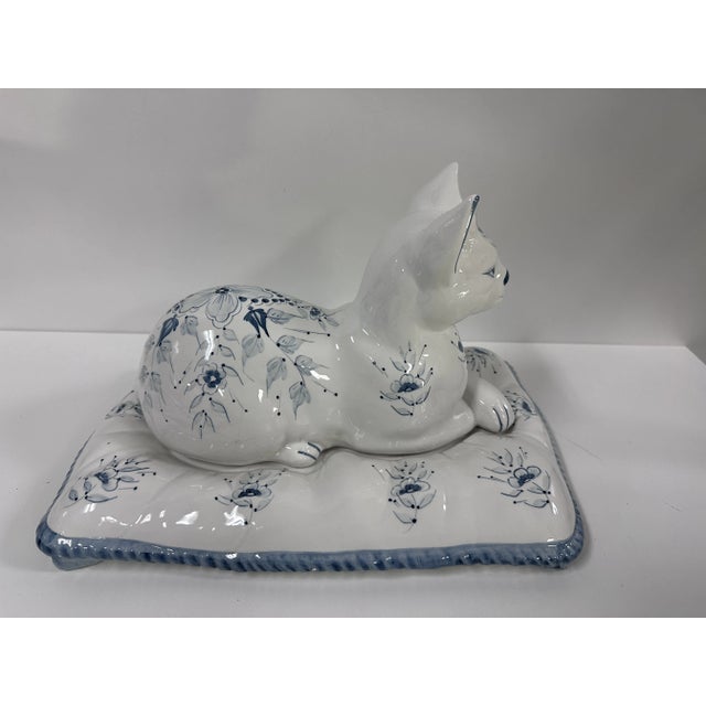 Meet your new favorite conversation starter: the Vintage Italian Ceramic Blue and White Cat Figurine on Pillow. This...