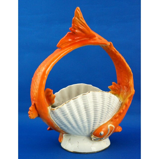 A stunning, large, hand-crafted, majolica and vitrified ceramic basket-shaped centerpiece, featuring a shell-shaped vase...