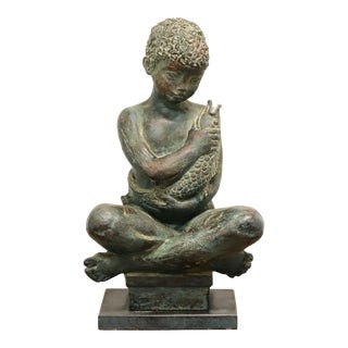 Patinated Bronze Seated Boy Holding Fish Sculpture For Sale