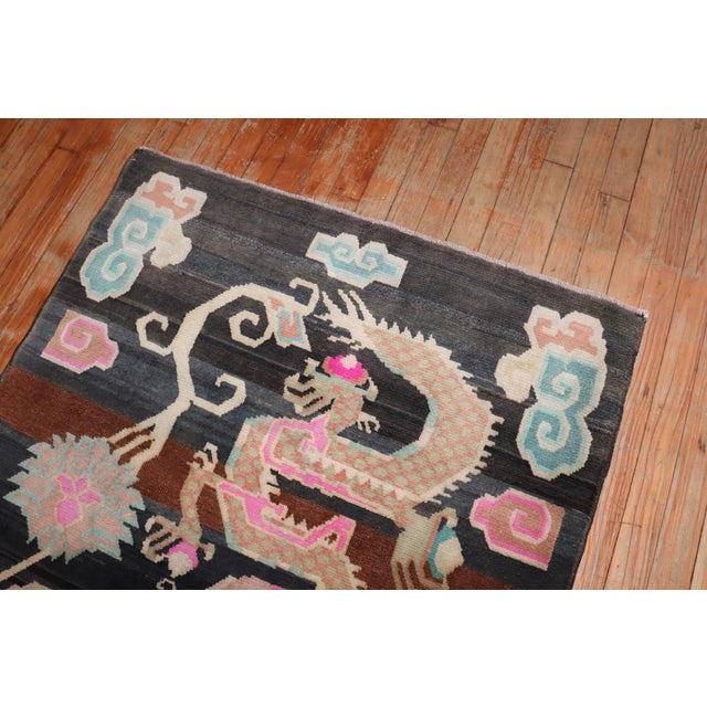A 3rd quarter of the 20th-century highly decorative Tibetan rug with a large double dragon motif. Size: 3'3'' x 5''7'.