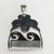Large pendant with made of sterling silver set with a carved goddess face so popular in Sajen designs. The dark waves...