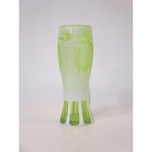 A hand cut glass vase with pineapple and palm tree motif in a cream and lemon lime toned glass in a nice size . This hard...