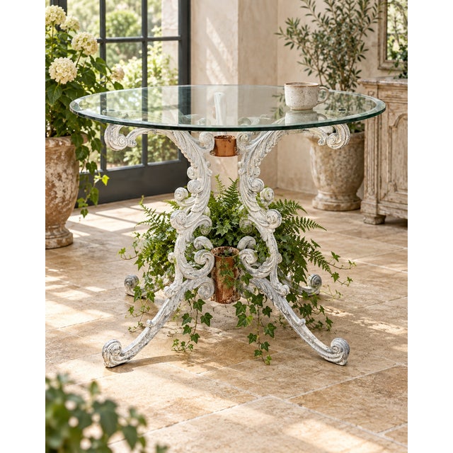 A sculptural late-20th-century Rococo Revival pedestal table with an intricately cast iron base and a 36-inch round clear-...
