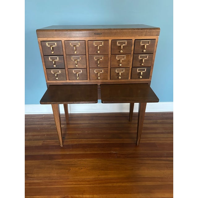 Solid maple Remington Rand 15-drawer library card catalog. Circa 1950s. Brass fittings, two slide-out shelves,...