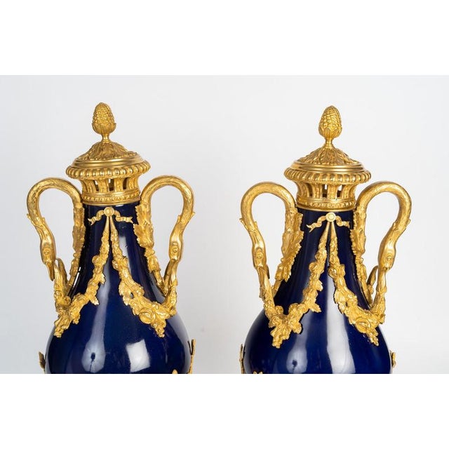 Pair of lidded vases in sèvres blue porcelain and gilded bronze, napoleon iii period, 19th century. Pair of lidded vases...
