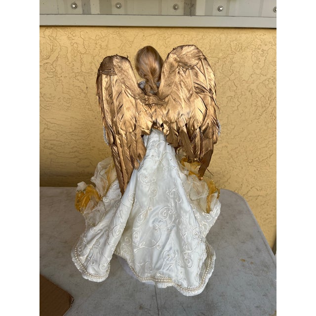 Large Angel Topper with Porcelain face and hands. Enhance your holiday décor with the elegance of this angel tree topper....