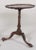 A fine George III mahogany tilt top side table with round pie crust tray rising on a vase turned stem above three claw...