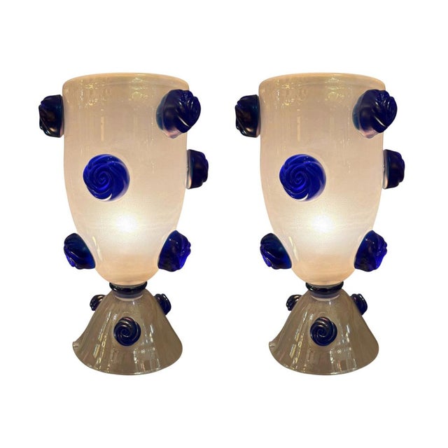 A pair of large Murano glass lamps designed by Carlo Colizza. Hand-blown Murano glass creates an hourglass silhouette,...