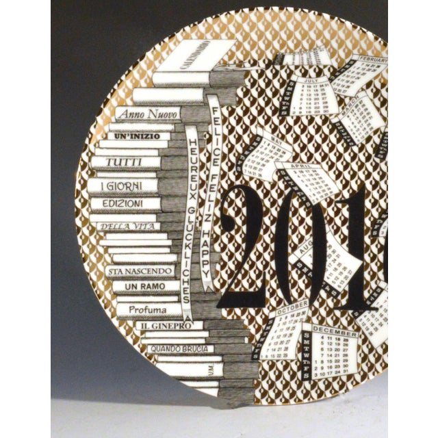 Barnaba Fornasetti Porcelain Calendar Plate 2016. Number 172 of 700. With Original Box. THe plate with a gold and white...
