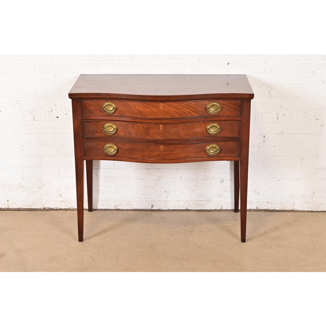 A gorgeous Federal or Georgian style serpentine front sideboard, credenza, or buffet server In the manner of Baker...