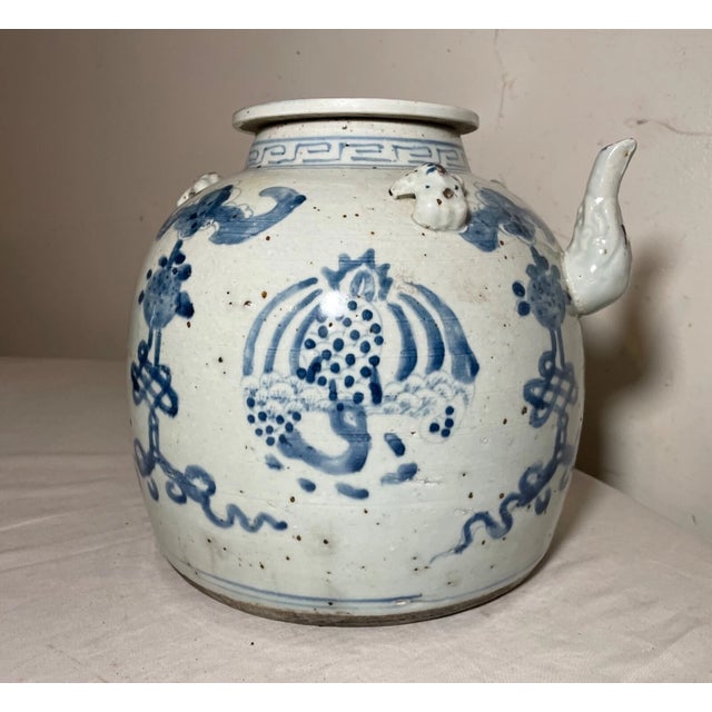 This exquisite teapot is a true antique piece from the 17th century Ming dynasty of China. Its delicate blue and white...
