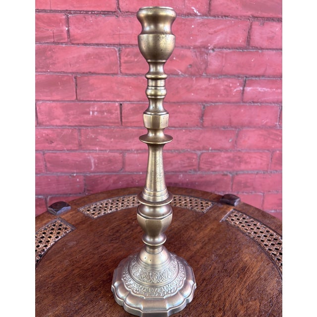 This is an elegant vintage brass 14.25 in candlestick by The Bombay Company, featuring a tall turned baluster-form stem...