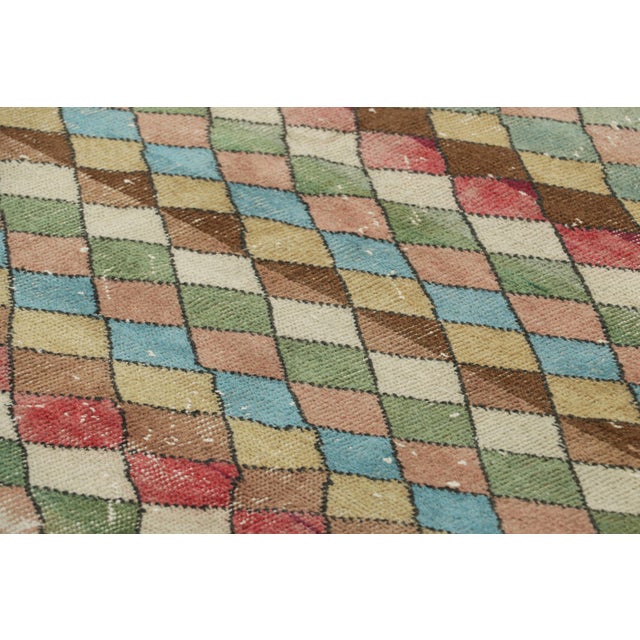 Made with hand-knotted wool and originating from Turkey circa 1960-1970, this 5x8 vintage rug is an exciting new piece in...