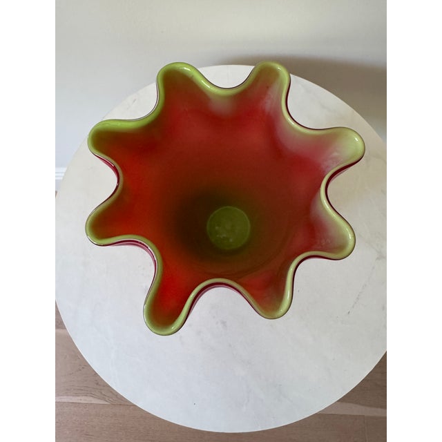 A stunning handkerchief vase in deep crimson red cased glass with a chartreuse green interior, circa 1960s. The...