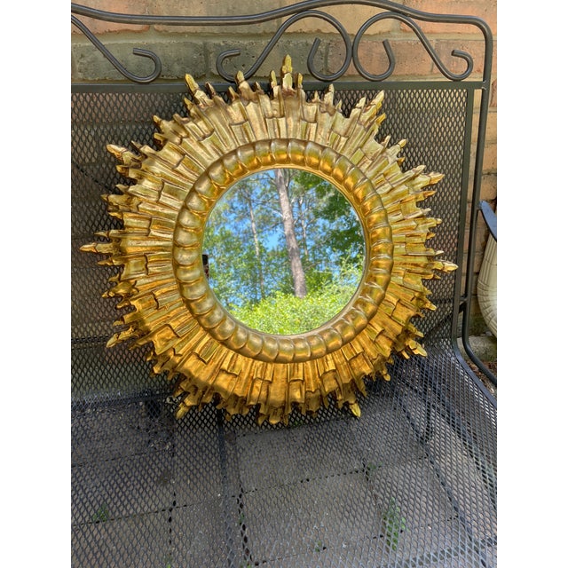 A gorgeous large 24" heavily Gilded and molded resin/polyfoam Sunburst Wall Mirror. Circa 1960s. Made in Italy tag on the...