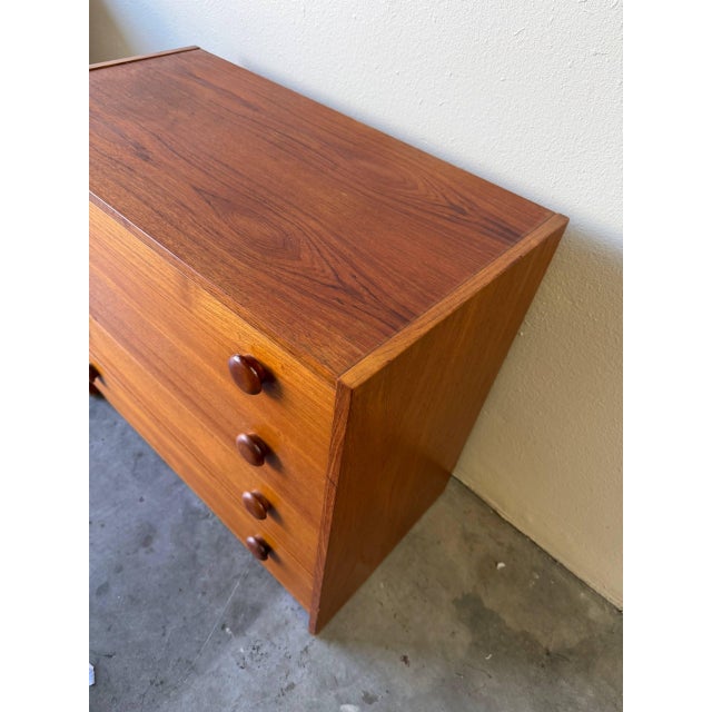 This vintage Danish chest of drawers showcases the timeless simplicity and craftsmanship of Mid-Century Modern...