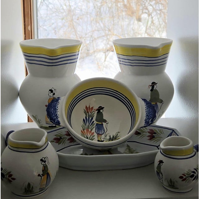 An authentic, numbered collection of vintage Henriot Quimper pottery, beautifully hand-painted in the traditional Breton...
