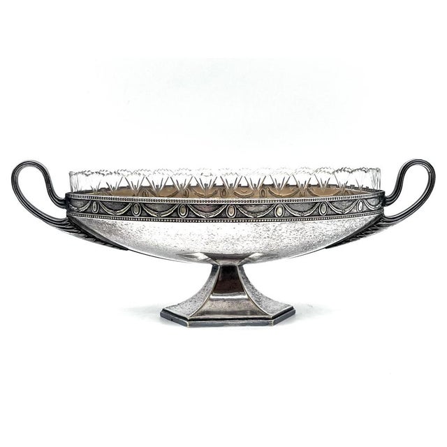 This elegant centerpiece, also known as a jardinière, is a classic combination of fine metalwork and glass design. The...