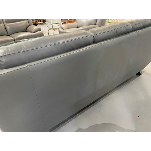 MODERN GRAY LEATHER THREE-SEAT SOFA WITH METAL BASE -Spacious three-seat gray leather sofa with padded back cushions, wide...