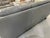 MODERN GRAY LEATHER THREE-SEAT SOFA WITH METAL BASE -Spacious three-seat gray leather sofa with padded back cushions, wide...