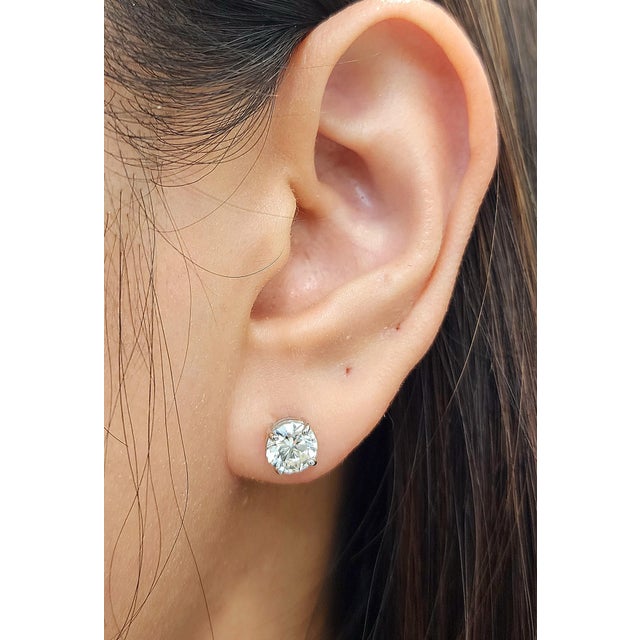 These timeless 14K white gold stud earrings feature 2.03 carats of round-cut white diamonds, graded G/H color and SI1/SI2...