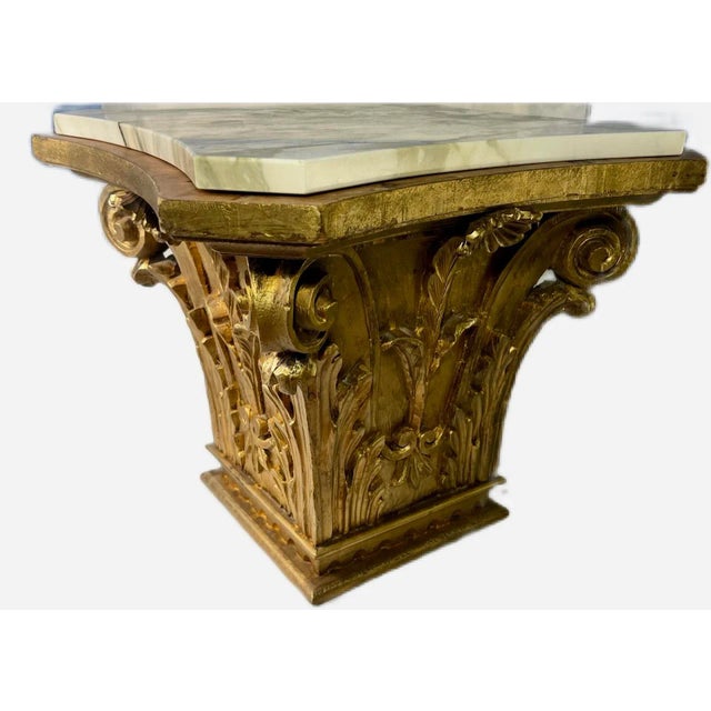 Add a classic touch to your decor with this fine wooden Corinthian capital table with a gold finish and fine marble top....