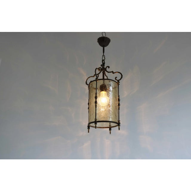 Elegant vintage brass pendant lantern with cylindrical textured glass, France, circa 1950s. This charming lantern features...