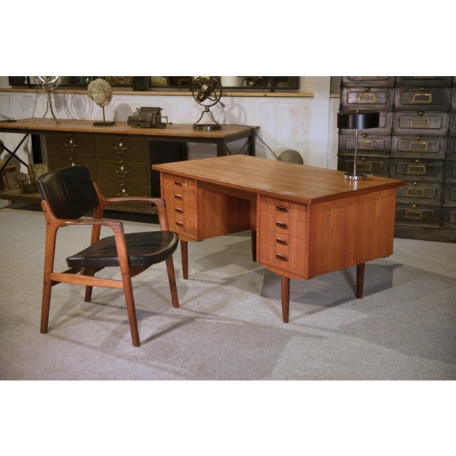 Clean lines, a minimalist top with softened edges, flush-fronted storage with integrated handles; tapered legs that...