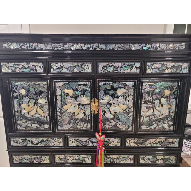 Elevate your space with this breathtaking vintage Korean Mother-of-Pearl inlay cabinet, a striking example of traditional...