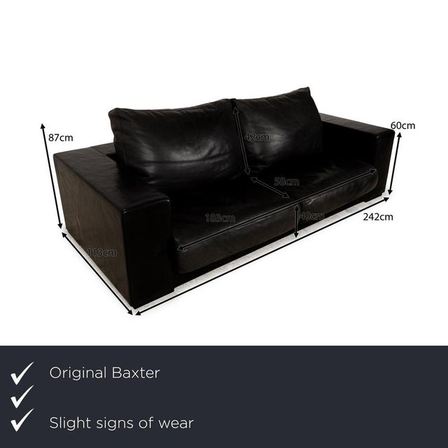 The three-seater Budapest from Baxter is covered in a very dark, almost black leather and stands on simple metal feet. It...