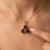 An earthy three-stone design featuring round-cut natural smoky quartz arranged in a graceful trefoil formation, secured in...