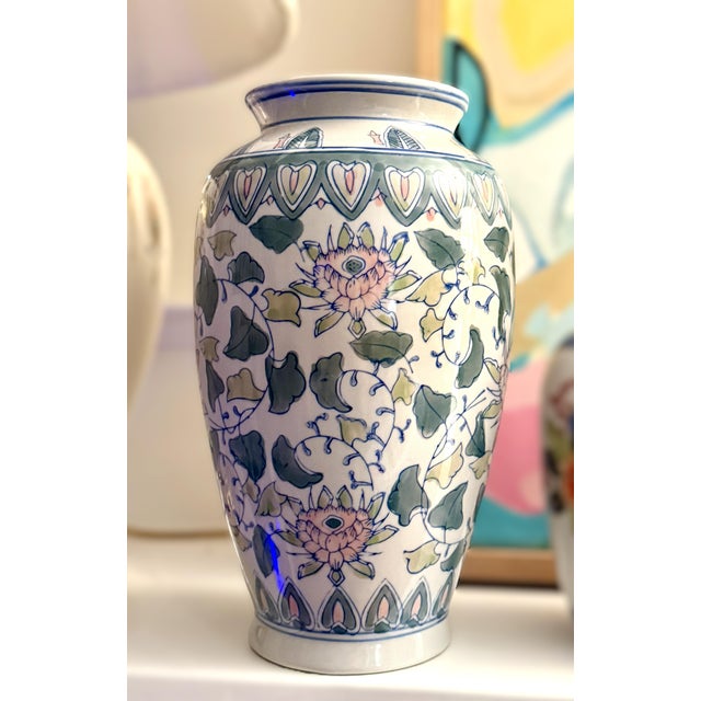 A very pretty matching pair of 10-inch porcelain vases. Hand-painted with a palette of soft pinks, greens, and blues. Each...