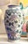 A very pretty matching pair of 10-inch porcelain vases. Hand-painted with a palette of soft pinks, greens, and blues. Each...