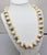 1980s Modernist ivory resin round beads with goldtone and rhodium plated "caps" single strand necklace with spring ring...