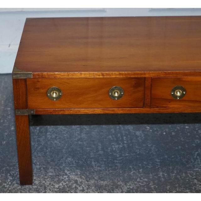 A striking vintage military campaign coffee table, beautifully crafted in richly figured burr yew wood and finished with...