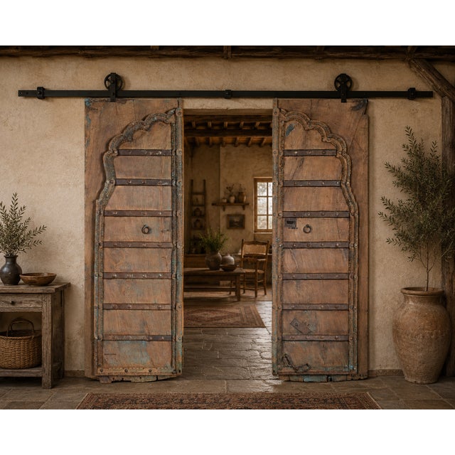 Antique Indian Carved Teakwood and Iron Door, the top with a shaped arch, with a carved outline and center style. A very...