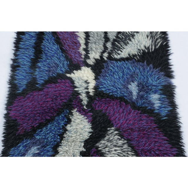 Hand-knotted in lush, high-pile wool in Sweden circa 1960-1970, this 2x3 vintage Swedish Rya rug is a bold new addition to...
