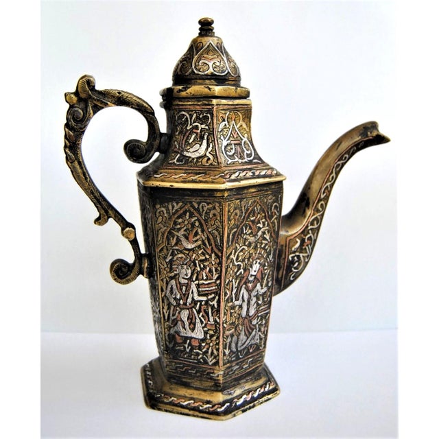 An engraved, silver-inlaid, brass coffee or tea pot, possibly Mosul, Ayyubid Syria-Iraq, late 19 century. Of typical form,...