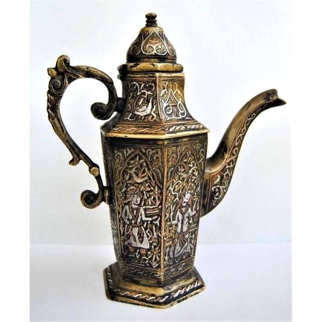 An engraved, silver-inlaid, brass coffee or tea pot, possibly Mosul, Ayyubid Syria-Iraq, late 19 century. Of typical form,...